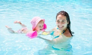 Child with mother in swimming pool